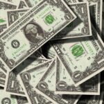 Close-up of scattered US dollar bills symbolizing finance and wealth.