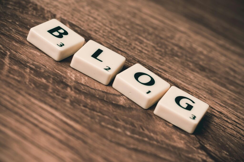 pexels-photo-262508-262508 Scrabble tiles spelling 'BLOG' on a wooden background, symbolizing creativity and writing.